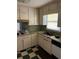 Practical kitchen featuring ample cabinet space, a sink with a view, and a retro aesthetic ready for a modern transformation at 1511 Stonewood Dr, Norcross, GA 30093