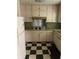 Functional kitchen with vintage cabinets, checkered floors, and essential appliances, ready for updates and customization at 1511 Stonewood Dr, Norcross, GA 30093