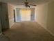 Spacious living room with sliding glass doors and neutral carpet, offering a blank canvas for personal design touches at 1511 Stonewood Dr, Norcross, GA 30093