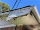 Shows peeling paint and damage on a roof area needing repair with a blue sky and trees in the background at 1511 Stonewood Dr, Norcross, GA 30093