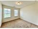Bedroom with carpeted floor and two windows at 421 Auburn Valley Way, Auburn, GA 30011