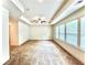 Bright bedroom featuring tray ceilings, carpeted floors and three large windows at 421 Auburn Valley Way, Auburn, GA 30011
