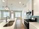 Modern kitchen featuring stainless steel appliances, light countertops and a double sink at 421 Auburn Valley Way, Auburn, GA 30011