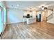 Open concept kitchen and living area features hardwood floors and stainless steel appliances at 421 Auburn Valley Way, Auburn, GA 30011