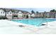Community pool surrounded by townhomes and black metal fencing provides a place to cool off at 421 Auburn Valley Way, Auburn, GA 30011