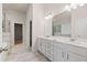 Elegant bathroom featuring double vanity, quartz countertops, and a walk-in glass shower at 4229 Brookmont Way, Auburn, GA 30011