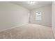 This bedroom offers carpet flooring, a ceiling light, and bright light from the window at 4229 Brookmont Way, Auburn, GA 30011
