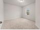 This is a bright bedroom with carpet flooring and a window letting in natural light at 4229 Brookmont Way, Auburn, GA 30011