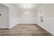 Bright dining room featuring hardwood floors, wainscoting, and modern chandelier at 4229 Brookmont Way, Auburn, GA 30011