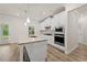 Modern kitchen with a granite island, stainless appliances, and white cabinetry at 4229 Brookmont Way, Auburn, GA 30011