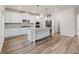 Kitchen with white cabinets, granite countertops, stainless appliances, and an island with a sink at 4229 Brookmont Way, Auburn, GA 30011