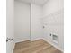 This laundry room features wood floors, wire shelving, and utility hookups at 4229 Brookmont Way, Auburn, GA 30011