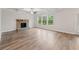 Spacious living room features wood floors, stone fireplace, and large windows providing lots of natural light at 4229 Brookmont Way, Auburn, GA 30011