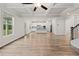 An open-concept floor plan with hardwood floors connects the living room to the kitchen at 4229 Brookmont Way, Auburn, GA 30011
