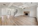 Large living room with hardwood floors, a stone fireplace, and coffered ceilings at 4229 Brookmont Way, Auburn, GA 30011