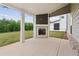 Covered back patio featuring an outdoor fireplace, providing a cozy outdoor living space at 4229 Brookmont Way, Auburn, GA 30011