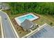 Aerial view of community pool and clubhouse with lush landscaping and ample parking at 4229 Brookmont Way, Auburn, GA 30011