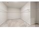 Spacious walk-in closet with ample shelving and neutral carpeting, ready for custom organization at 4229 Brookmont Way, Auburn, GA 30011