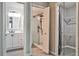 Bathroom with a walk-in shower with glass door, tile surround, and modern vanity at 68 Hampshire Ct, Avondale Estates, GA 30002