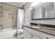 Bright bathroom featuring a shower-tub combination and granite countertop vanity at 68 Hampshire Ct, Avondale Estates, GA 30002