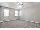 Bright bedroom featuring plush gray carpet, two windows and neutral painted walls at 68 Hampshire Ct, Avondale Estates, GA 30002