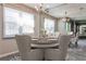 This dining room is bright with a large window, elegant chandelier, and an inviting space to entertain guests at 68 Hampshire Ct, Avondale Estates, GA 30002