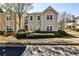 Well-maintained townhome exterior with manicured landscaping and a parking area at 68 Hampshire Ct, Avondale Estates, GA 30002