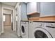 Convenient laundry area with modern front load washer and dryer and adjacent storage space at 68 Hampshire Ct, Avondale Estates, GA 30002