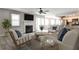 Inviting living room with a cozy fireplace, plush seating, and an open layout to the kitchen and dining area at 68 Hampshire Ct, Avondale Estates, GA 30002