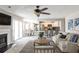 This living room features an open concept with a dining room and kitchen, and a fireplace with large sliding glass doors at 68 Hampshire Ct, Avondale Estates, GA 30002