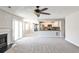 Open-concept living room with fireplace, sliding glass doors, and access to kitchen and dining area at 68 Hampshire Ct, Avondale Estates, GA 30002
