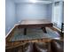 Basement featuring a pool table covered on a rug and hardwood floors and brown leather sofa at 2669 Ambria Dr, Buford, GA 30519