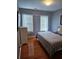 Bedroom with hardwood floors, two windows, and a comfortable bed and pillows at 2669 Ambria Dr, Buford, GA 30519