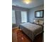 Bedroom with hardwood floors, two windows, and a comfortable bed and pillows at 2669 Ambria Dr, Buford, GA 30519