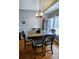 Cozy dining room with wood floors, gray walls, and modern light fixture above the table at 2669 Ambria Dr, Buford, GA 30519