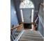 Foyer with hardwood floors, and a view of the front door with a large arched window above at 2669 Ambria Dr, Buford, GA 30519