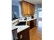 Eat-in kitchen features wooden cabinetry, laminate countertops and stainless steel sink and faucet at 2669 Ambria Dr, Buford, GA 30519
