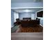 Cozy living room featuring hardwood floors and comfortable brown leather seating and large TV at 2669 Ambria Dr, Buford, GA 30519