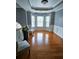 Bright living room with large bay window, hardwood flooring, and modern decor at 2669 Ambria Dr, Buford, GA 30519
