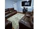 Living room featuring light colored rug and comfortable brown leather seating and large TV at 2669 Ambria Dr, Buford, GA 30519