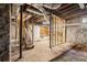 Unfinished basement with stone walls and concrete flooring offering potential for customization at 28 Exeter Rd, Avondale Estates, GA 30002