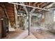 Unfinished basement featuring exposed utilities, stone walls, and a set of wooden stairs at 28 Exeter Rd, Avondale Estates, GA 30002
