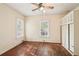 Bedroom features hardwood floors, ceiling fan, and two large windows at 28 Exeter Rd, Avondale Estates, GA 30002
