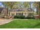 Charming single-story home with well-manicured lawn, complemented by lush landscaping and a welcoming entryway at 28 Exeter Rd, Avondale Estates, GA 30002