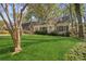 Beautifully landscaped front yard of a light brick house, featuring manicured shrubs and mature trees at 28 Exeter Rd, Avondale Estates, GA 30002