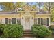 Close up of a delightful home featuring classic shutters, sconces, and a neatly maintained lawn at 28 Exeter Rd, Avondale Estates, GA 30002