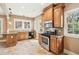Traditional kitchen featuring wood cabinets, stainless steel appliances and a sunlit window at 28 Exeter Rd, Avondale Estates, GA 30002