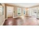Bright and airy living room showcasing beautiful hardwood floors and access to the sunroom at 28 Exeter Rd, Avondale Estates, GA 30002