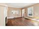 Cozy living room featuring pristine hardwood floors, a classic fireplace, and large windows for natural light at 28 Exeter Rd, Avondale Estates, GA 30002