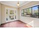 Cozy sunroom with brick floor, large window and access to outdoor porch at 28 Exeter Rd, Avondale Estates, GA 30002